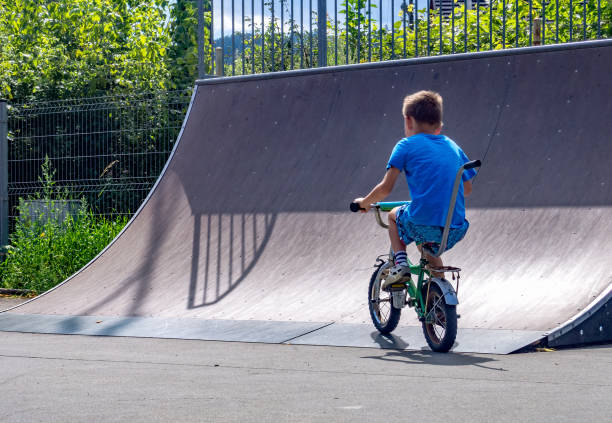 istock Boy riding bike in skate park 858388372