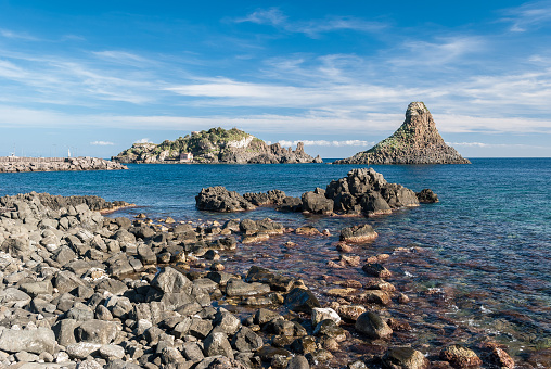 Island Lachea and a sea stack, geological features in Acitrezza (Sicily)