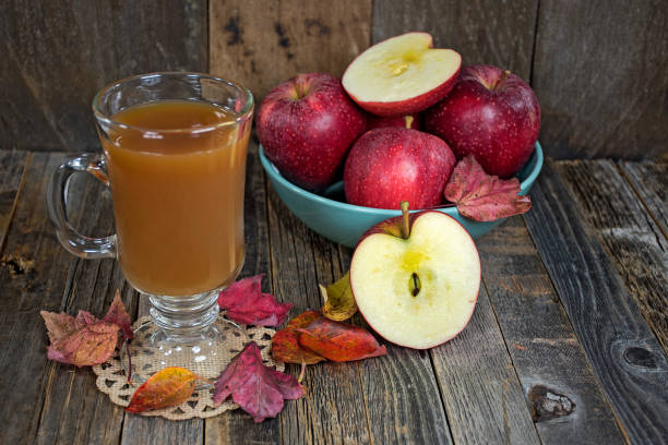 istock apple cider with apples and leaves 858404156