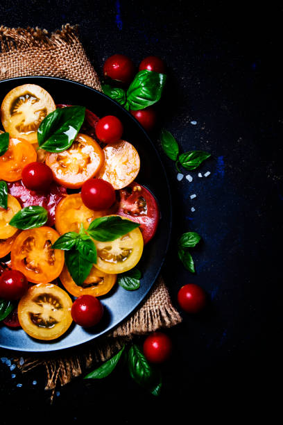 istock Italian salad with mini mozzarella, green basil, cherry tomatoes, balsamic vinegar and olive oil 858408480