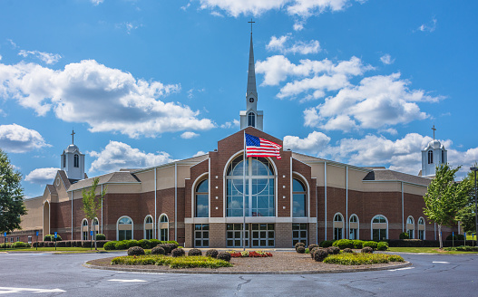 A huge church, Church at Liberty Square, with an American flag in front