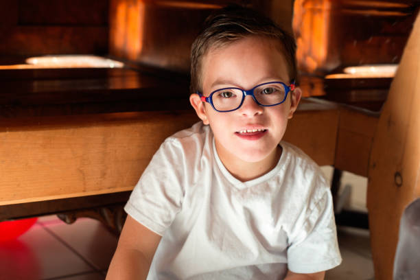 Positive depictions of sweet little girl 8 years old and his smiling brother 7 years old with Down syndrome. They spend time together, have fun outdoors and indoors. The pictures are authentic with real people. In Quebec Canada.