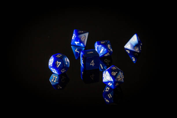 Six Blue Role Playing Gaming Dice on a Reflective Surface Moody, Shadowy Photo of Six Blue Role Playing Gaming Dice Displayed on a Reflective Surface, with a Dark Black Background developing 8 stock pictures, royalty-free photos & images
