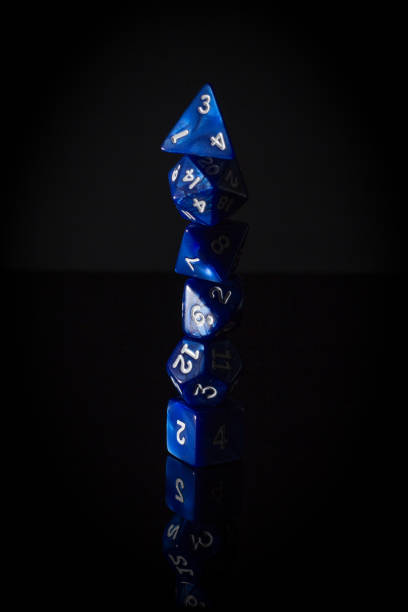 Six Blue Role Playing Gaming Dice Stacked Vertically Moody, Shadowy Photo of Six Blue Role Playing Gaming Dice Stacked Vertically on a Reflective Surface, with a Dark Black Background developing 8 stock pictures, royalty-free photos & images