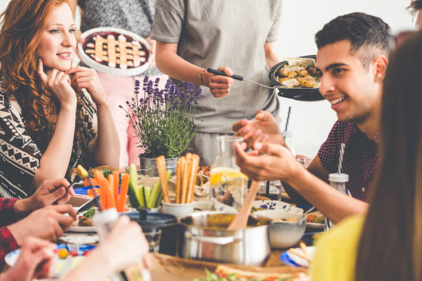 istock Mixed-race friends enjoying vegetarian lunch 858426928