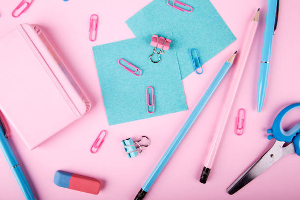 istock Blue and pink office. A lot of school objects on a pink background. 858430218
