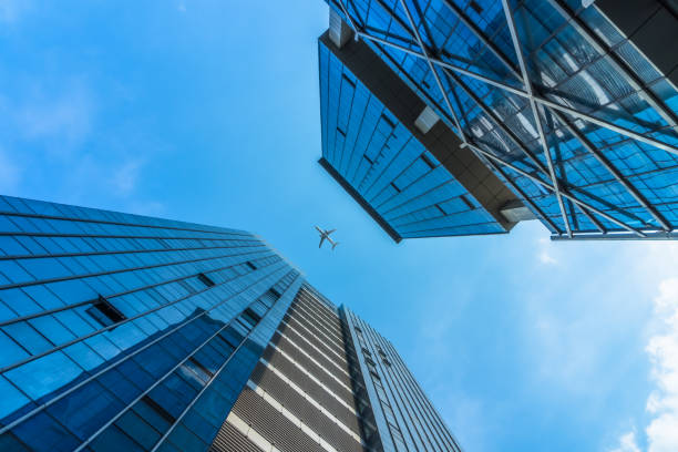 istock Plane flying over the skyscrapers 858433830