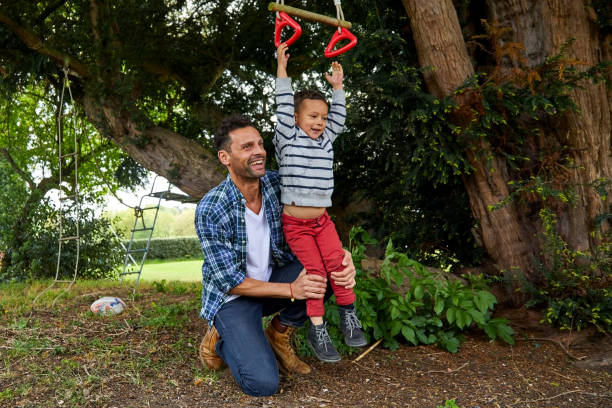 istock Little boy playing with his father at playground 858434498