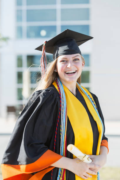 istock Young woman graduating from high school or university 858445998
