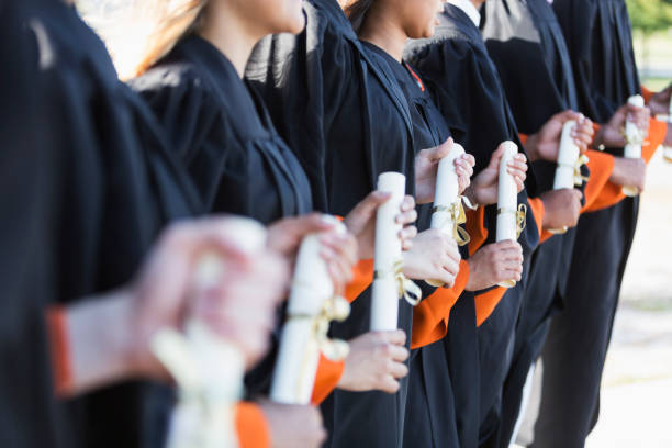 istock Multi-ethnic teenage graduates in cap and gown 858446044