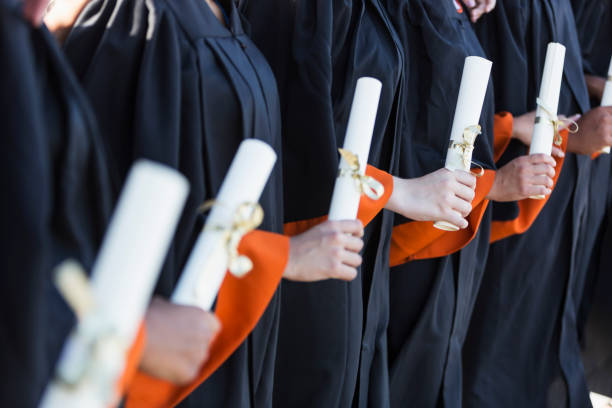 istock Multi-ethnic teenage graduates in cap and gown 858448062