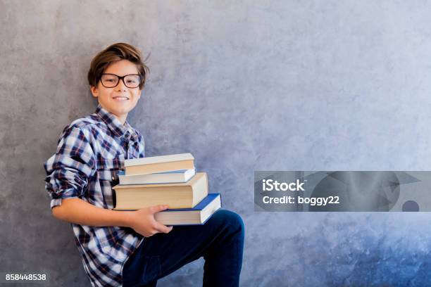 Cute Teenage School Boy Holding Books Stock Photo - Download Image Now - Book, Charming, Cheerful
