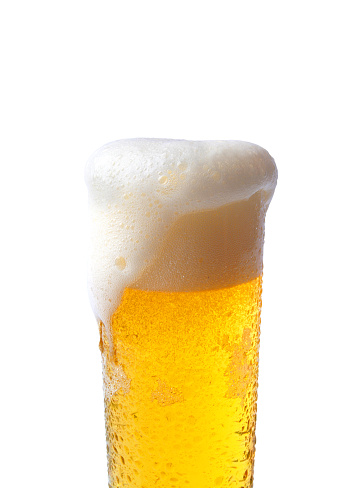 Beer glass with overflowing foam