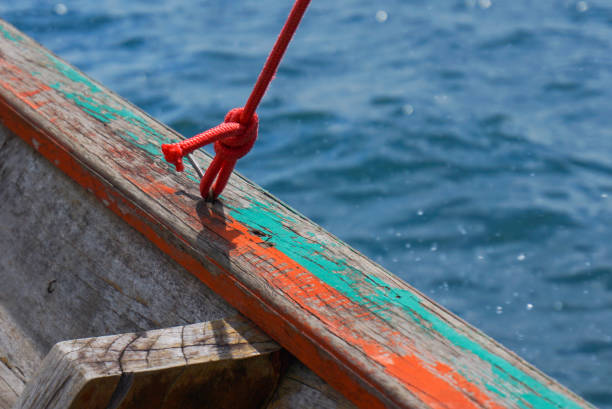 istock red rope in wooden boat for background 858455092