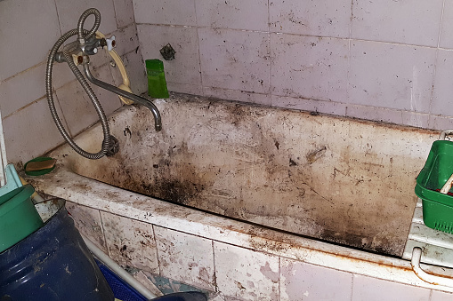 Very dirty and neglected bathroom. Concept: poverty, the social problem of the loneliness and lack of care about elderly people