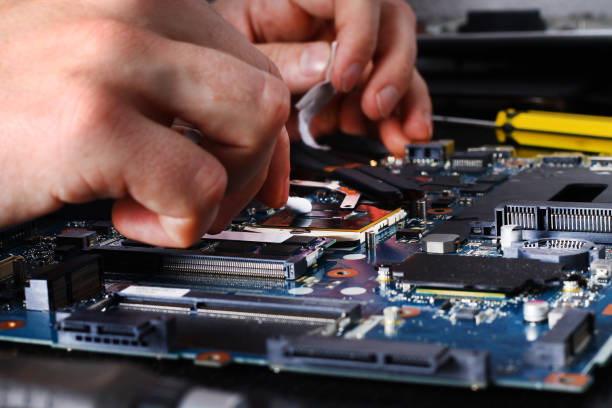 istock Computer literacy repair men hands, man examines laptop clean thermal paste 858458494