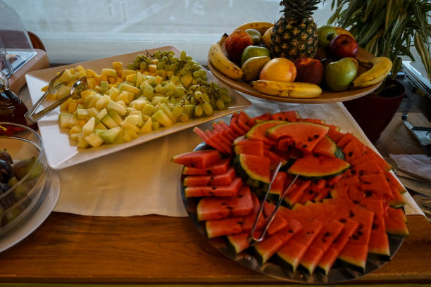 istock Greek breakfast buffet table full with varieties of fresh fruit including cantaloupe, watermelon, grape, banana, apple, pineapple, etc. 858472016