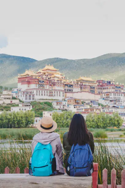 Female tourists are traveling in Little Potala Palace Lamasery"nThe famous temple in shangri-la , yunnan , china