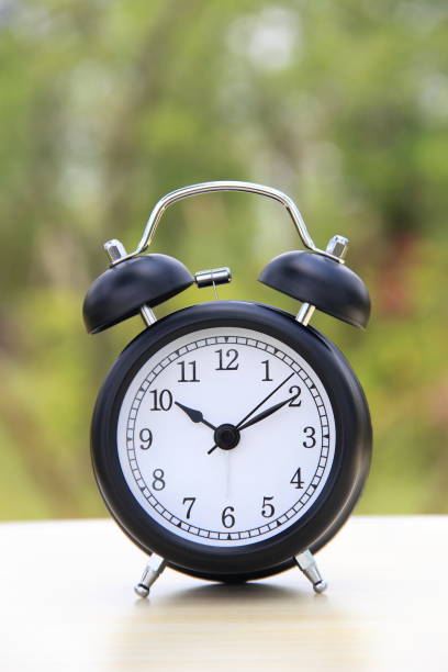 istock Alarm clock on a table outdoors 858472438