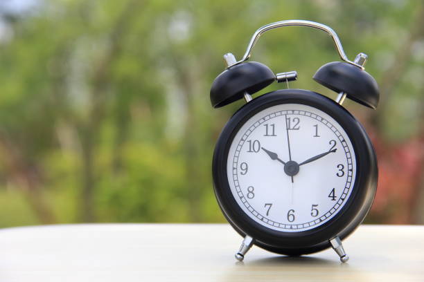 istock Alarm clock on a table outdoors 858472482