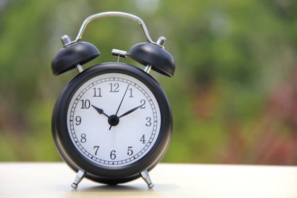 istock Alarm clock on a table outdoors 858472516