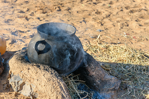 Cooking pot on fire in the village Merzouga, Morocco