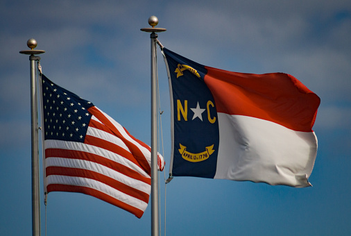 The NC state flag flies alongside the stars and stripes.
