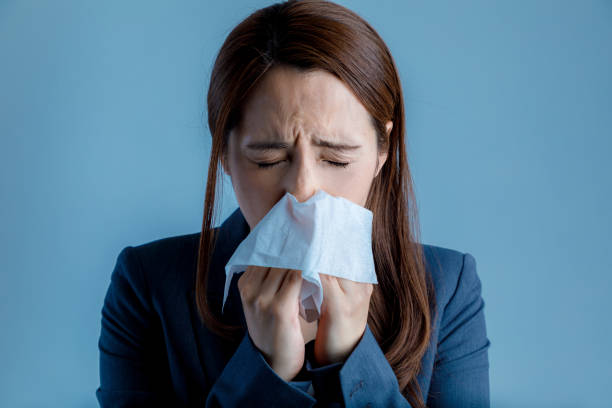 young woman blowing her nose. allergic rhinitis. hay fever. - hay fever imagens e fotografias de stock