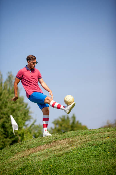 istock FootGolf Player Kicking Soccer Ball 858486436