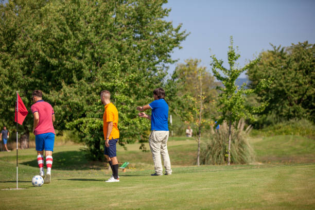 istock FootGolf Players and the Coach on the Golf Course 858486462