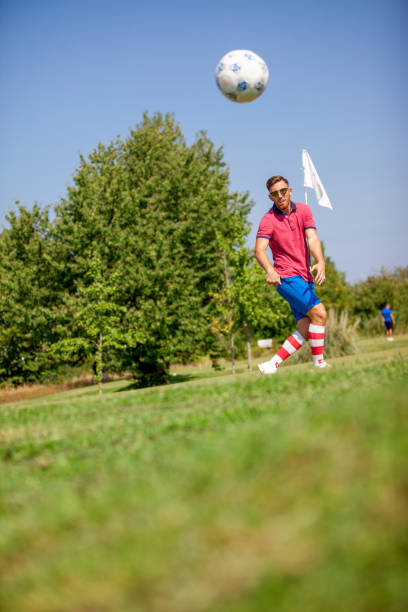 istock Young FootGolf Athlete Striking Soccer Ball 858486492