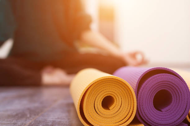 Closeup view of yoga mat and woman on background stock photo