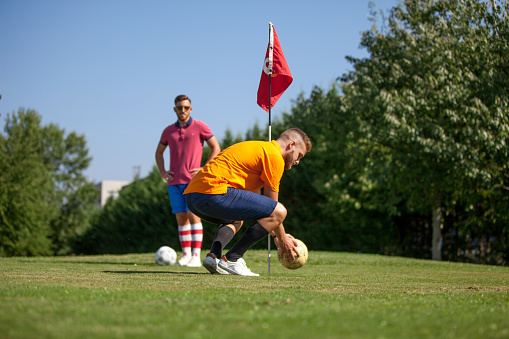 Two FootGolf Players on Golf Course near the Hole