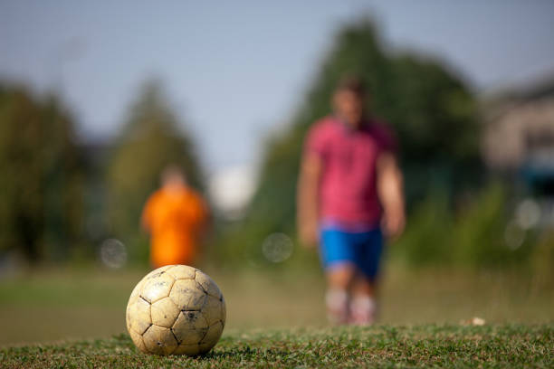 Soccer Ball and Two Blurred Athletes in the Background