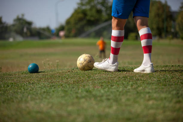 istock FootGolf Athlete Legs in Striped Socks Close-up 858486648