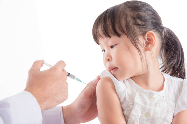 little girl receiving injection or vaccine stock photo