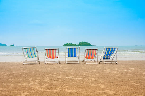 istock Paradise view from beach deck chairs  on island in sea. 858493982