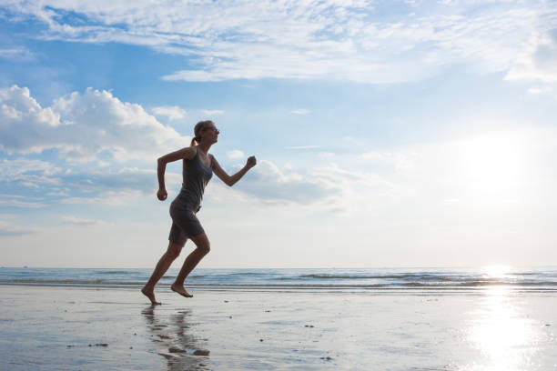 istock Jogging woman on the sea beach 858494262