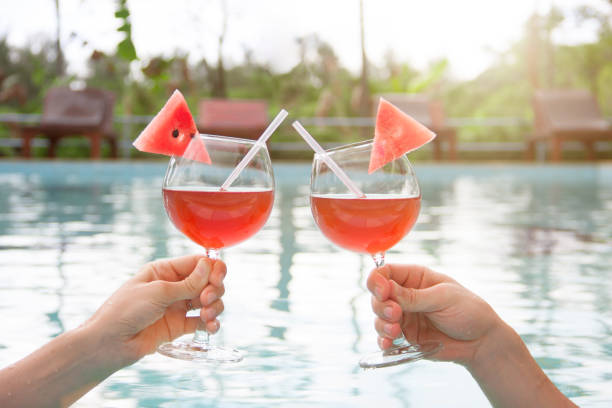 istock Couple holding glasses with juice and bendie. 858498672