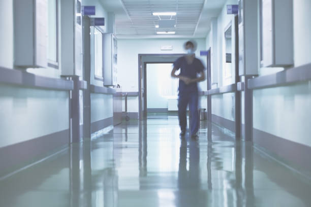 istock Blurred walking person in hospital hall 858504540