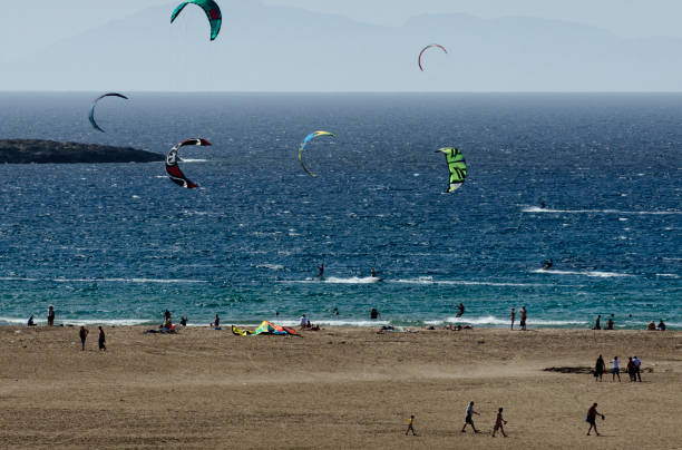 istock Sandy beach and the kitesurfers on the waves 858507040