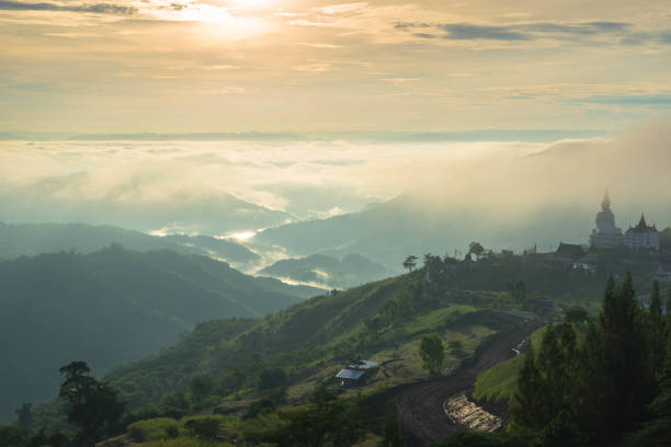 istock Panoramic view of mountain range in the mist under the sunrise 858507636