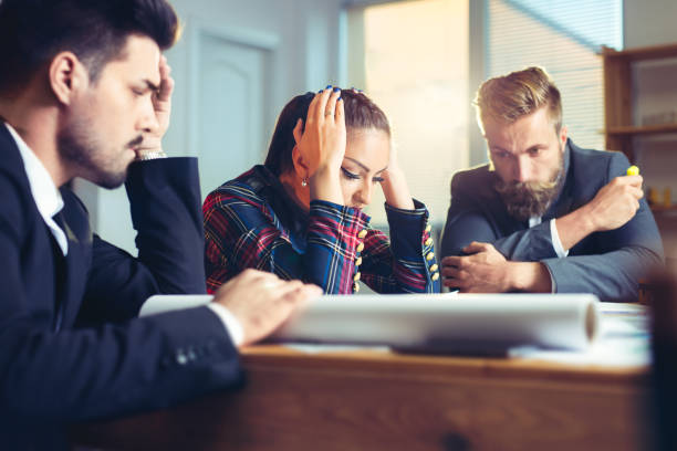 istock Frustrated business people sitting at the table in office 858508414