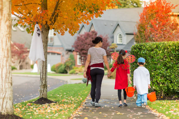 istock Two Children in Halloween Costumes Trick or Treating 858508510