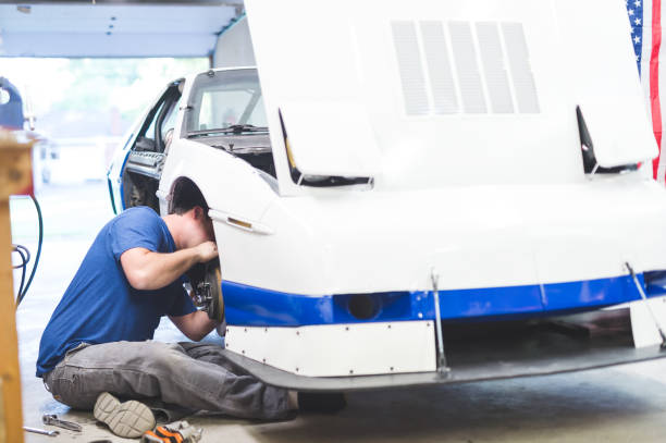 istock Mechanic works on car in his home garage 858511838