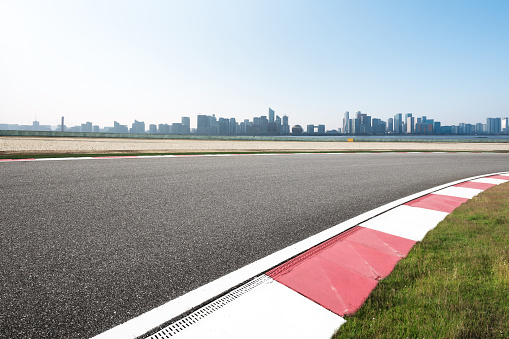 empty asphalt road in modern circuit and cityscape of hangzhou in blue cloud sky