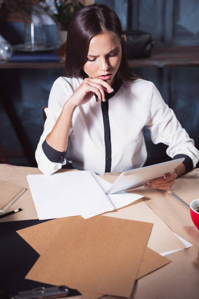 istock Young beautiful woman working with cup of coffee 858514960
