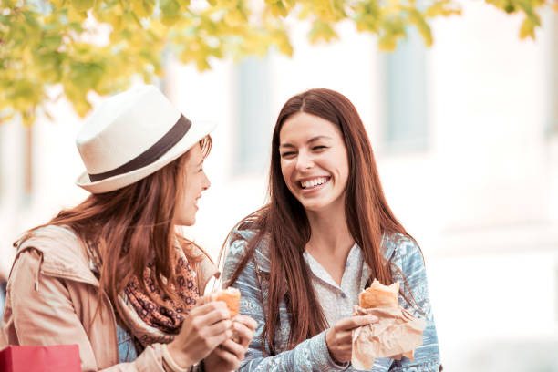 istock Two women having lunch outdoors 858518564