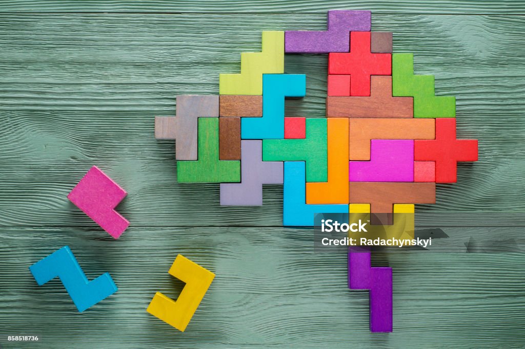 Human brain is made of multi-colored wooden blocks. Human brain is made of multi-colored wooden blocks. Creative medical or business concept. Toy Block Stock Photo