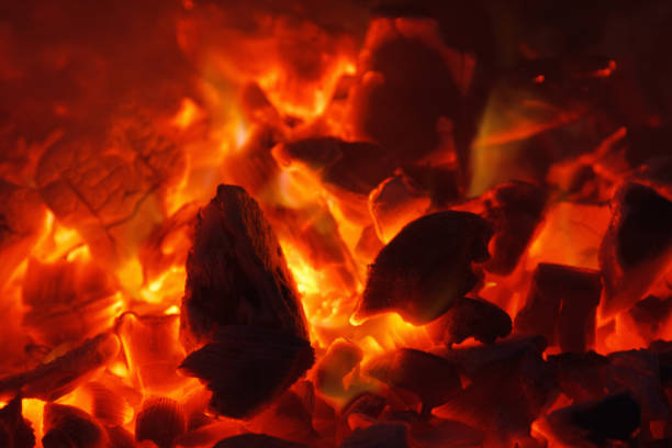 istock Glowing hot charcoal briquettes close-up background texture. bonfire 858519590